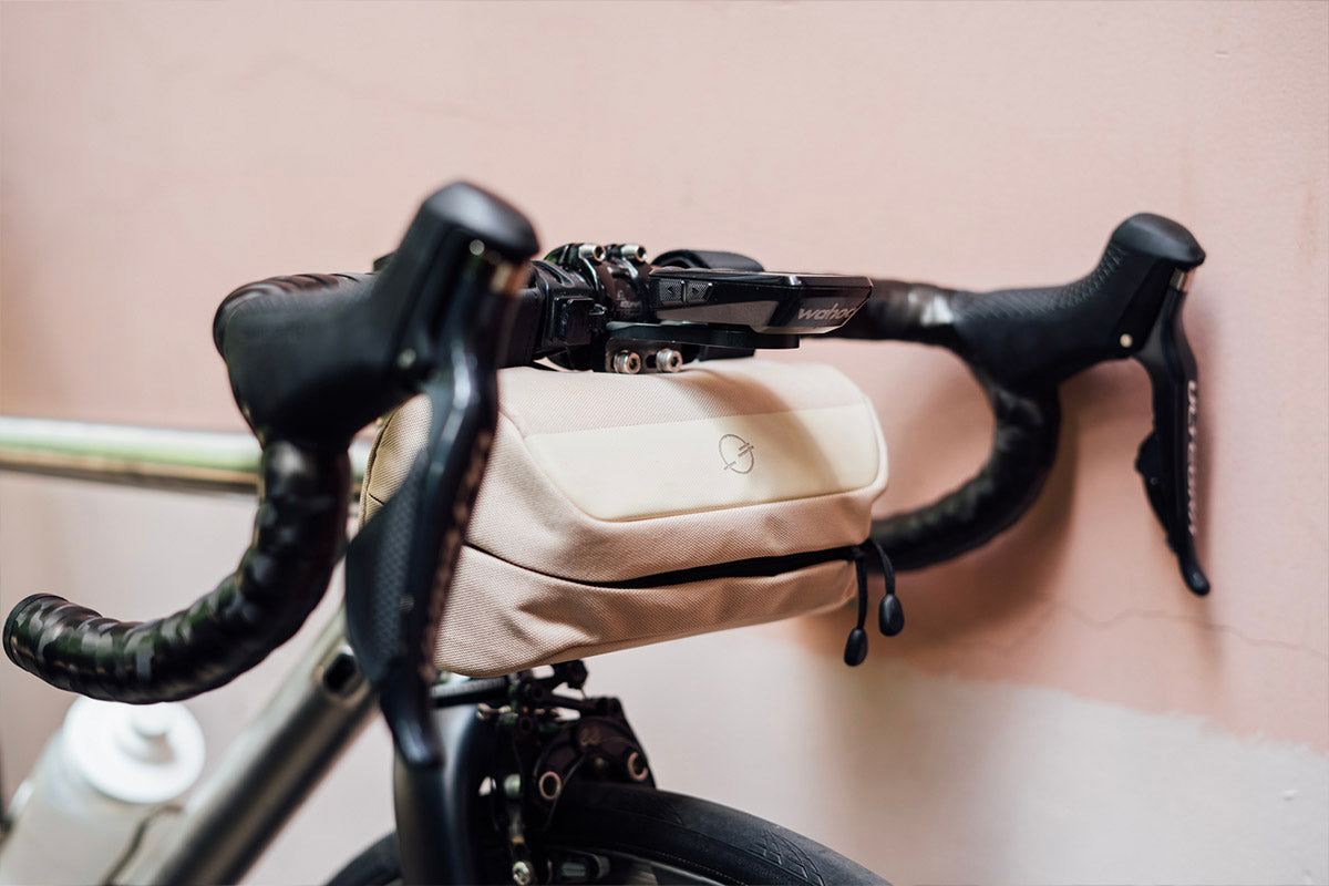 Front-quarter view shot a gravel bike with the Post Carry Co. Mini Handlebar Bag mounted on the bike