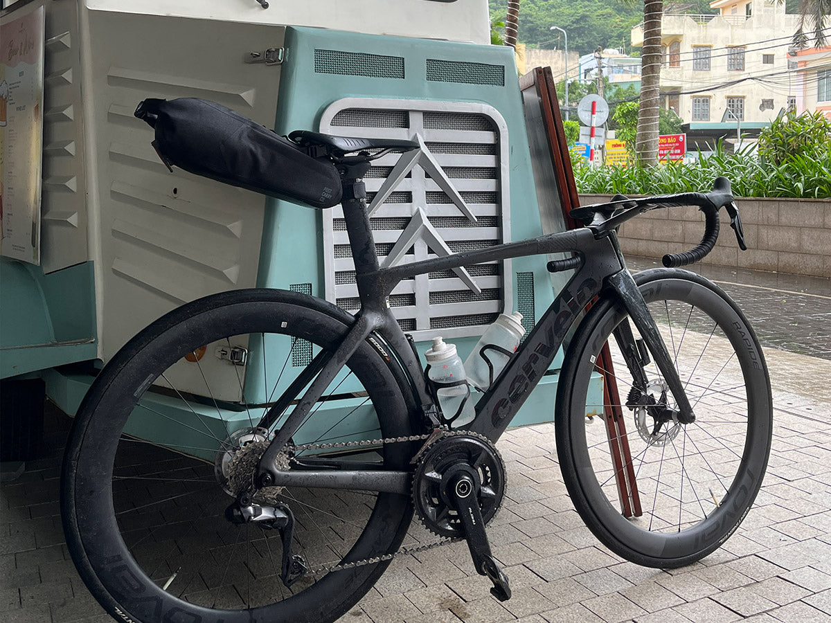 The Post Carry Co. Seat Pack mounted under the saddle of a Cervelo road bike shown from the side