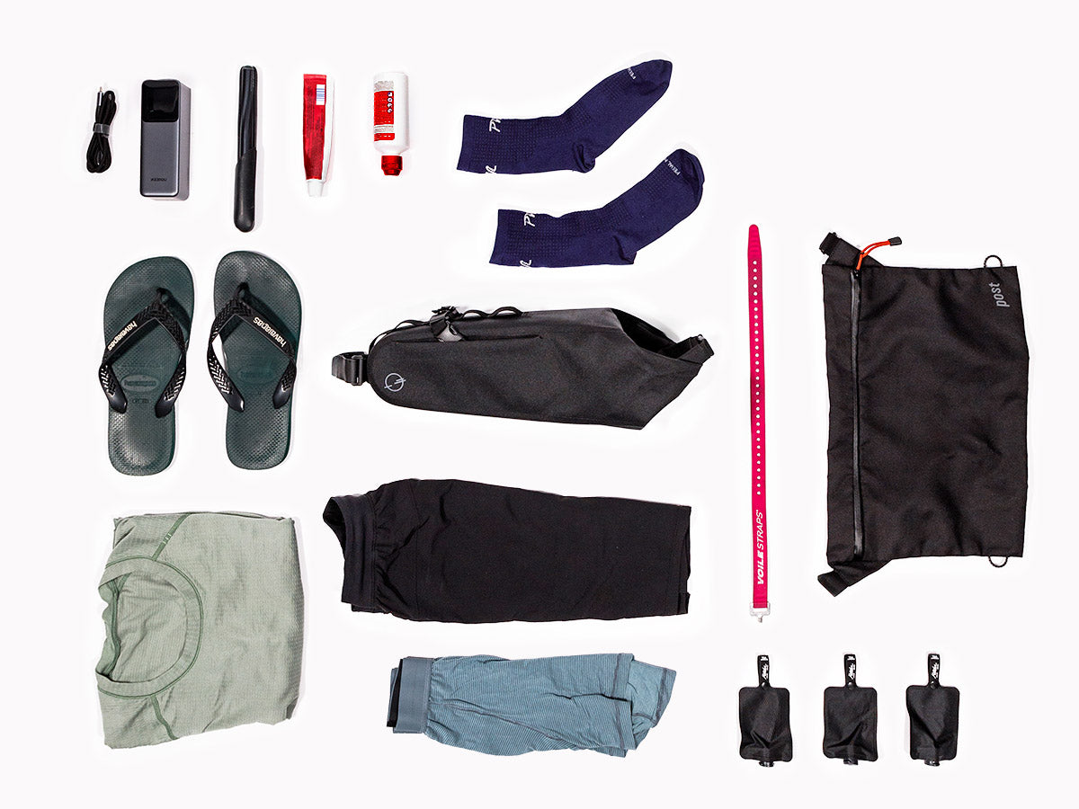 An image showing the contents laid out on a white ground showing what contents can fit in the Post Carry Co. Seat Pack