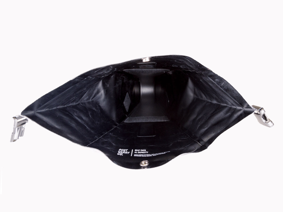 A rear view shot showing the interior of the Post Carry Co. Seat Pack when its rolltop is opened