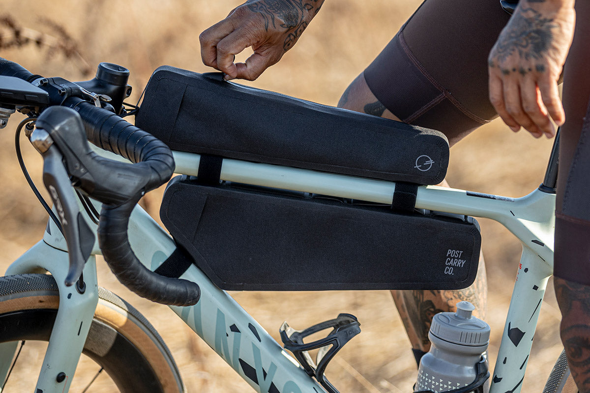 Side view of the Post Carry Co. Slim Frame Pack and Top Tube Pack mounted on a bicycle