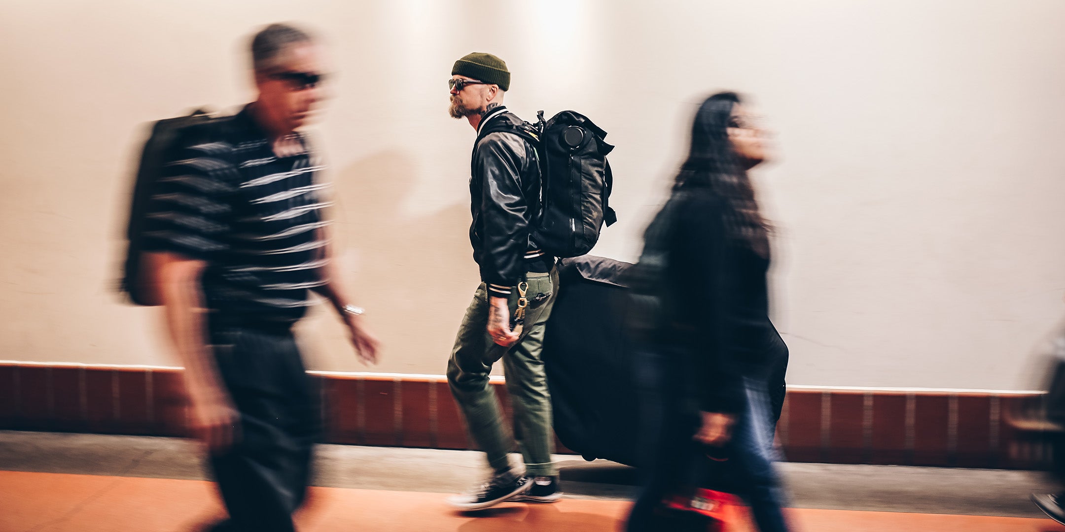 A person rolling the Post Carry Co. Transfer Case through a transit terminal