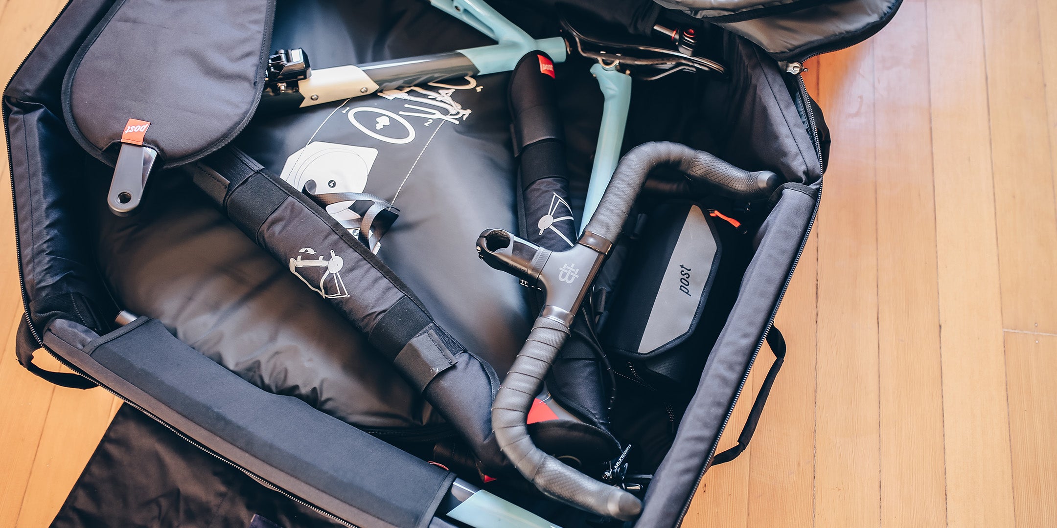 A cropped photo showing a road bike packed inside the Post Carry Co. Transfer Case