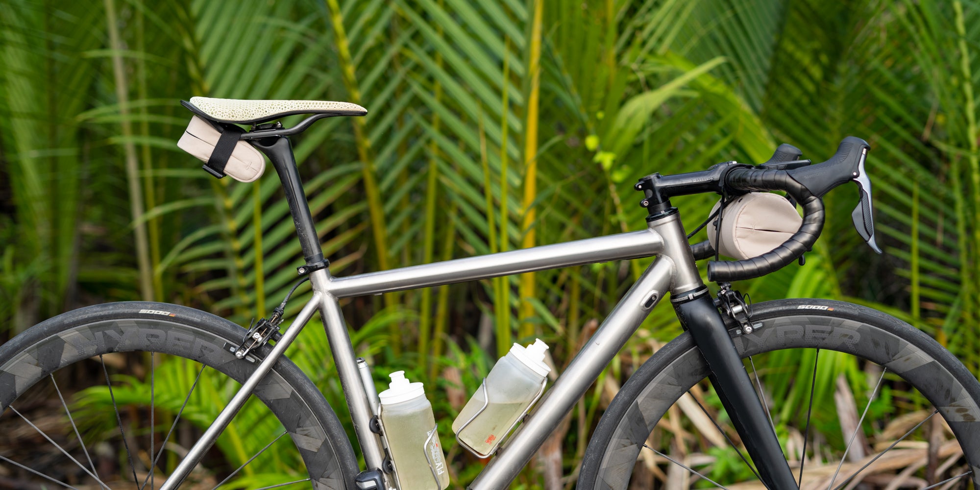 Side view shot a road bike with the Post Carry Co. Saddle Bag and Mini Handlebar Bag mounted on the bike